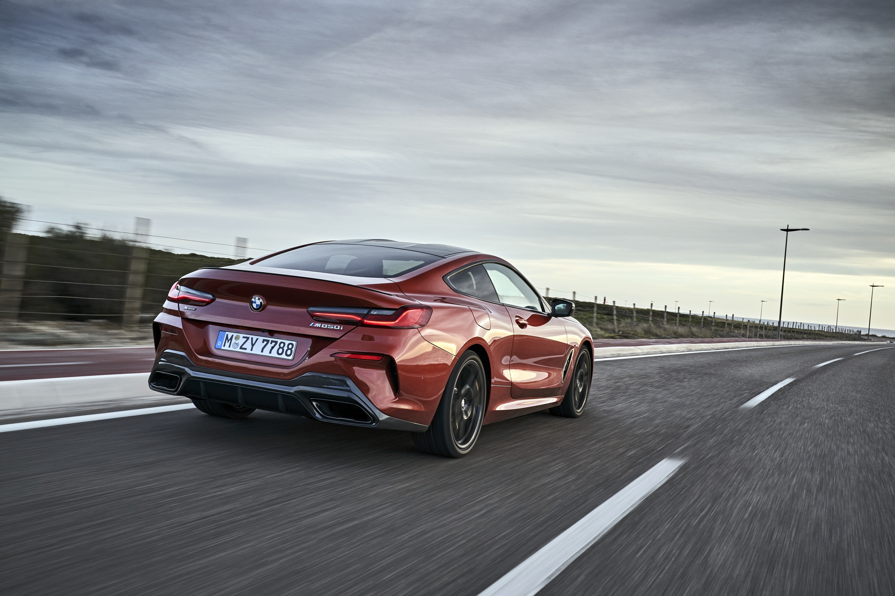 Rear view of BMW 8 Series driving on a road